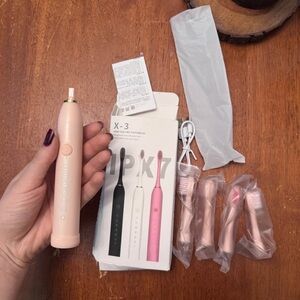 Brand new Pink Electric Toothbrush with 4 Heads